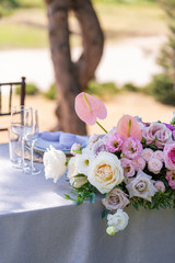 Bouquets of fresh flowers decoration of the festive table. Celebrating an open air party. Decor Details