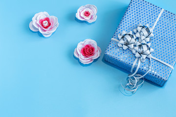 Gift box Packed in blue paper on a blue background .