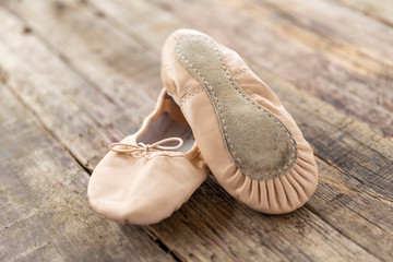 ballet shoes  laying on rough vintage wood, with natural light, Ballet shoes for Kids