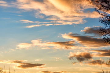 Obraz premium Bright sunset on the background of cloudy sky.