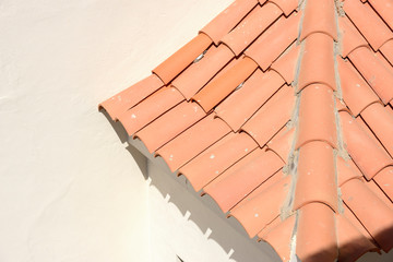 Small area of sloping tile roof adjacent to the wall.