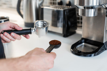 Guy prepare delicious aromatic coffee in a coffee machine. A simple way to make coffee