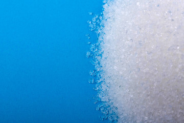 white granulated sugar on an blue background