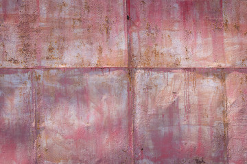 pink background of a painted rusty metal surface 