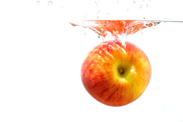 Red apple with water splash and isolated on white background