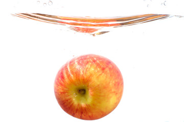Red apple with water splash and isolated on white background