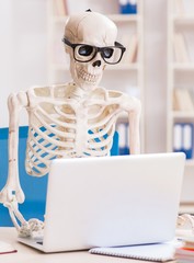 Skeleton businessman working in the office