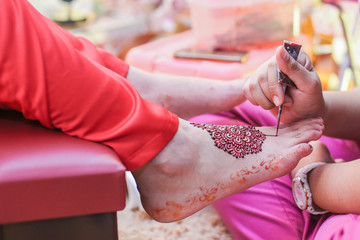 Very beautiful and unique henna paintings on both legs of the bride.