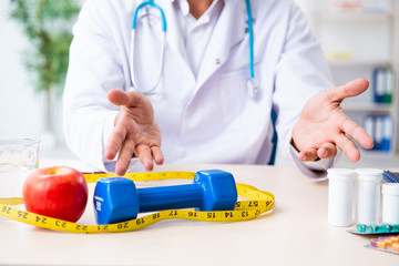 Young male doctor in sport and dieting concept