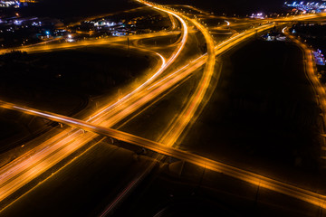 Fototapeta na wymiar Aerial view of a highway with cars at night. Poland. Drone shot Above of elevated road junction and traffic an important transport at night. 