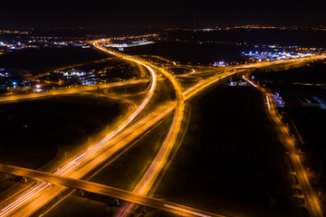 Fototapeta na wymiar Aerial view of a highway with cars at night. Poland. Drone shot Above of elevated road junction and traffic an important transport at night