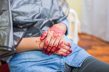 Very beautiful and unique henna paintings are on both hands of the bride.