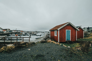 Vrångö, Southern Gothenburg Archipelago / Sweden - A view of sea shore, a rocky landscape of Vrångö island and its scandinavian wooden houses in Sweden during a cloudy day.