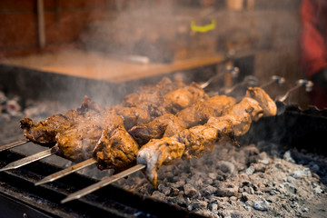 Cooking homemade barbecue on an open fire. Street Food Festival.