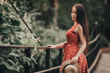 Young girl in retro dress posing in nature.