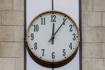 Street big watch. The dial is on the street against the wall. classic dial hands show twelve hours