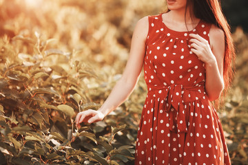 Young girl in retro dress posing in nature.
