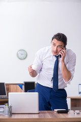 Young male businessman working in the office