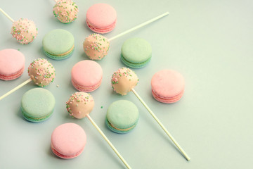 Sweet colorful macaroons with cake pops on sticks. Above view. Space for your copy