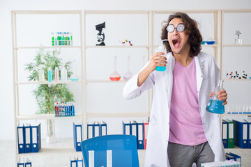 Funny male chemist working in the lab