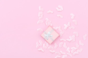 Gift box with hearts on a pink background. Valentine`s day.
