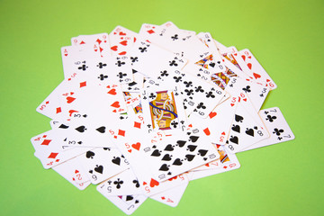 Random Poker cards over a green background