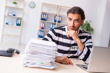 Young employee feeling like prisoner at work