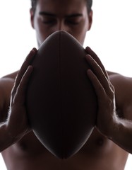 Ripped young man with american football isolated on white