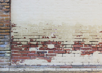 white damaged wall with orange bricks and colorful frame - beige wallpaper background 
