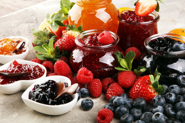 assortment of jams, seasonal berries jelly, mint and fruits and tangerine