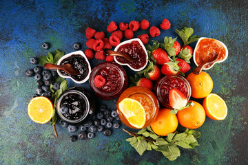 assortment of jams, seasonal berries jelly, mint and fruits and tangerine