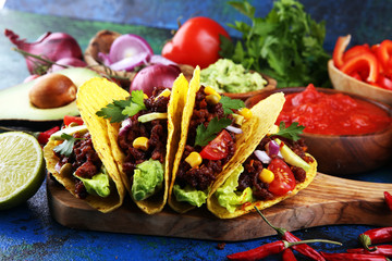 Mexican tacos with beef, tomatoes, avocado, chilli and onions. Handmade tortilla with pork