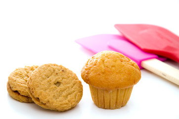 Carrot Muffin with Cookies, Red and Pink Spatula Isolated on White
