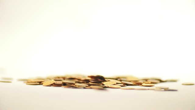 White-gloved hands scooping up a pile of gold coins. They sort out and scatter money.On white background. Garland. Money glitters.