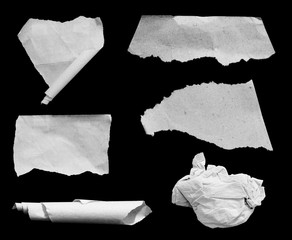 collection of ripped in paper on black , space for copy