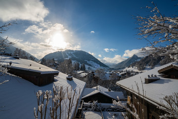 Fototapeta premium Gstaad, Switzerland - 01.01.2019: Winter view of snow covered roofs