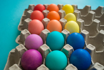 Easter eggs are the color of the rainbow. Blue background.