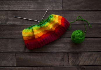 Yarn for knitting rainbow. Wood background.
