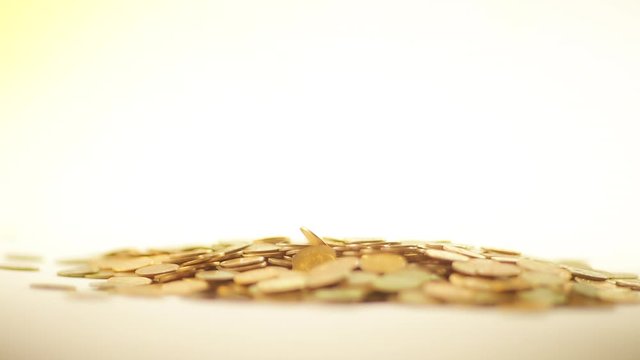 White-gloved hands scooping up a pile of gold coins. They sort out and scatter money.On white background. Garland. Money glitters.