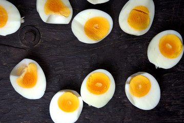 Close up of slice of boiled eggs on wooden.