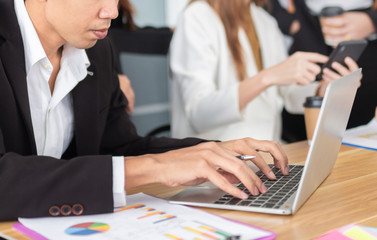 Fototapeta premium smart asian man officer typing report with laptop, he prepare information to executive conference, leadership and organization management