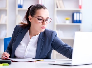 Businesswoman working in the office at desk