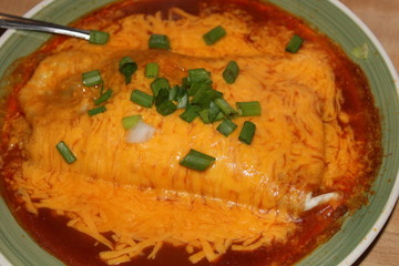 Home Made Enchilada with green onins and Melted yellow Cheese that's Yummy.
