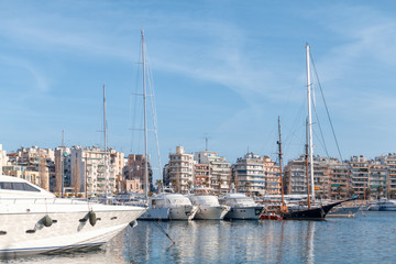 Pier with moored yachts in port. High class lifestyle. Luxury summer vacation.  Maritime walking. Yachting sport. Marina with anchored boats. Balearic islands, Majorca. Travelling and tourism concept.