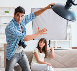 Young photographer working in photo studio