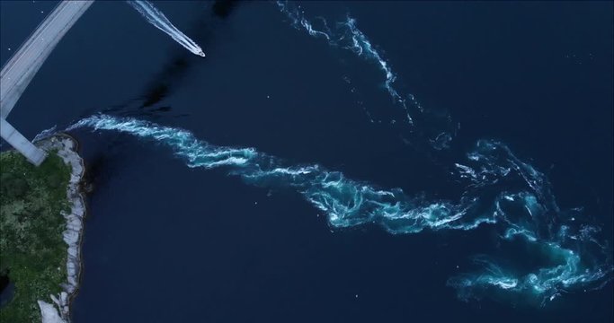 4K Boat crossing Saltstraumen current tide vortex. Bird's eye view drone footage