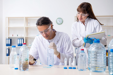 Two chemists working in the lab