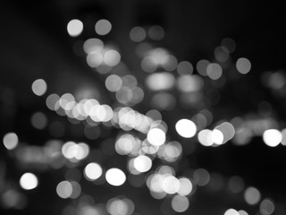 Night city street lights bokeh background for design, black and white