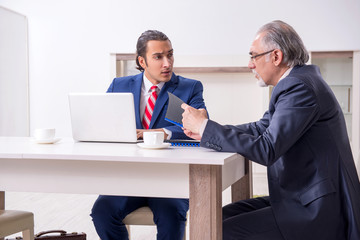 Two businessman discussing business in office