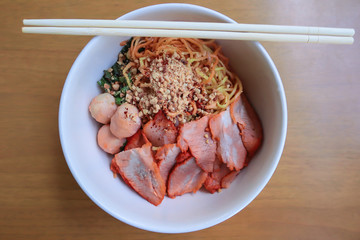 Dried egg noodles with roasted pork on the table